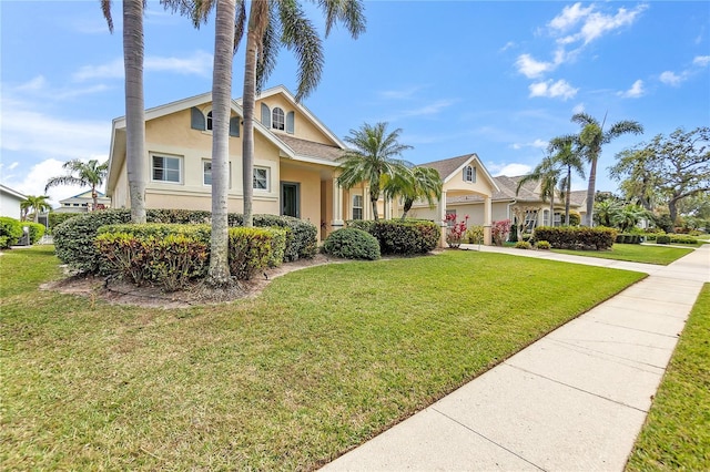 view of front of property featuring stucco siding, a front lawn, and driveway