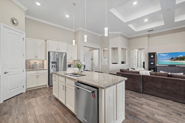 kitchen with a high ceiling, stainless steel appliances, a sink, and wood finished floors