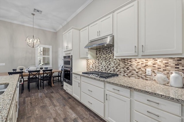 kitchen featuring under cabinet range hood, visible vents, appliances with stainless steel finishes, and ornamental molding