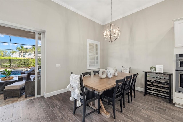 dining space with crown molding, a notable chandelier, dark wood finished floors, and baseboards