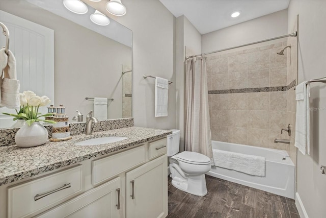 full bathroom featuring vanity, shower / tub combo, wood finished floors, and toilet