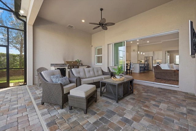 view of patio / terrace featuring visible vents, area for grilling, glass enclosure, ceiling fan, and an outdoor living space