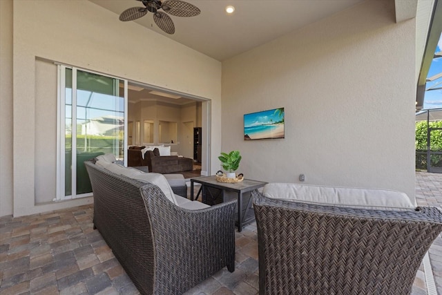 view of patio / terrace with glass enclosure, ceiling fan, and outdoor lounge area