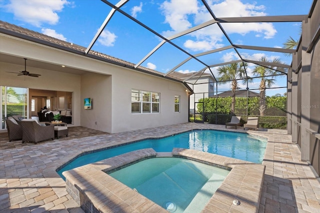 view of swimming pool featuring a ceiling fan, a patio, glass enclosure, a pool with connected hot tub, and outdoor lounge area