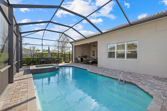 view of pool featuring a ceiling fan, a lanai, a patio area, and a pool with connected hot tub