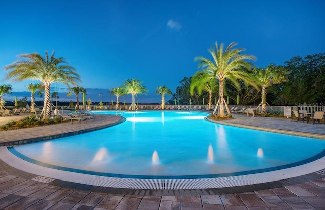 community pool featuring a patio area and fence