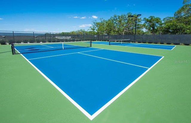 view of sport court featuring community basketball court and fence