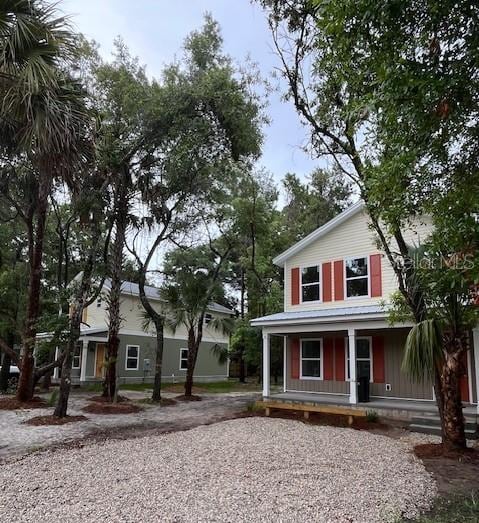 view of front of home featuring driveway and a porch