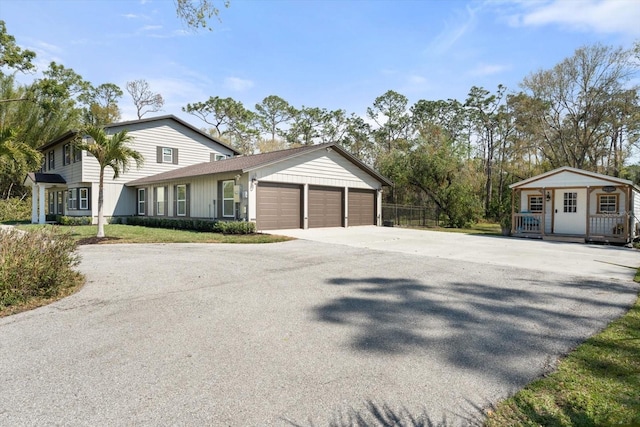 view of front of property with a garage and fence