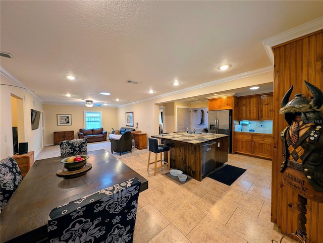 32 Fallen Oak Ln, Palm Coast, FL 32137 - kitchen with crown molding, black dishwasher, open floor plan, an island with sink, and a sink