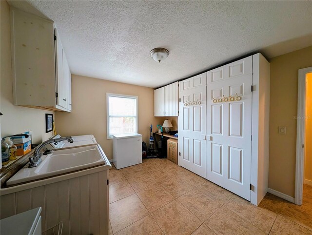 32 Fallen Oak Ln, Palm Coast, FL 32137 - kitchen with light tile patterned floors, a sink, white cabinetry, fridge, and baseboards