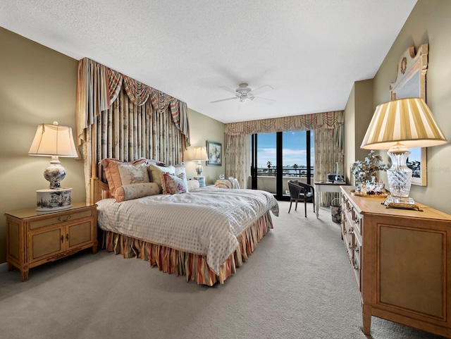 bedroom featuring a ceiling fan, access to outside, light colored carpet, and a textured ceiling