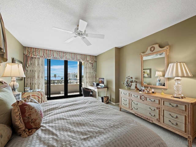 bedroom with a textured ceiling, carpet flooring, a ceiling fan, baseboards, and access to outside