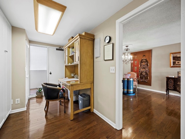 office area featuring dark wood-style flooring, a textured ceiling, and baseboards