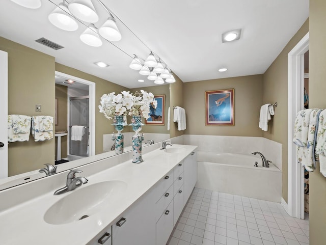 bathroom featuring a stall shower, tile patterned flooring, visible vents, and a sink