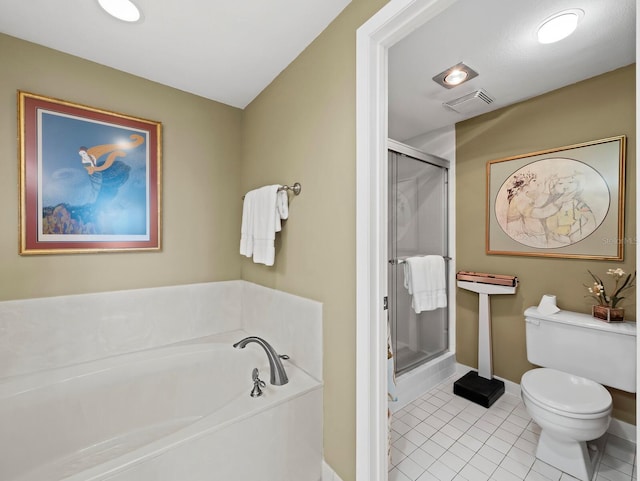 bathroom featuring a shower stall, toilet, tile patterned floors, and a garden tub