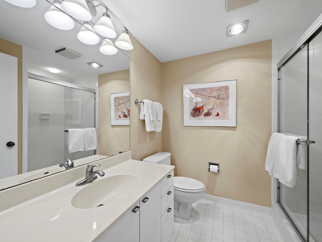 bathroom with tile patterned flooring, a shower stall, toilet, vanity, and baseboards