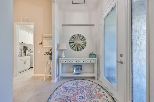 4516 Renwick Dr, Parrish, FL 34219 - foyer entrance with light tile patterned flooring and washer / dryer