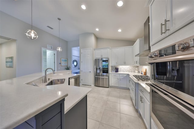 4516 Renwick Dr, Parrish, FL 34219 - kitchen featuring appliances with stainless steel finishes, light countertops, tasteful backsplash, white cabinets, and decorative light fixtures