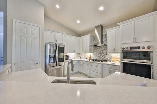4516 Renwick Dr, Parrish, FL 34219 - kitchen featuring stainless steel appliances, wall chimney exhaust hood, light countertops, tasteful backsplash, and white cabinetry