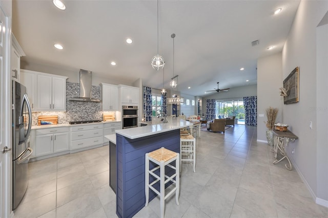4516 Renwick Dr, Parrish, FL 34219 - kitchen featuring wall chimney range hood, appliances with stainless steel finishes, tasteful backsplash, open floor plan, and recessed lighting