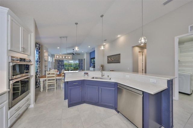 4516 Renwick Dr, Parrish, FL 34219 - kitchen with stainless steel appliances, washer / dryer, light countertops, open floor plan, and blue cabinets