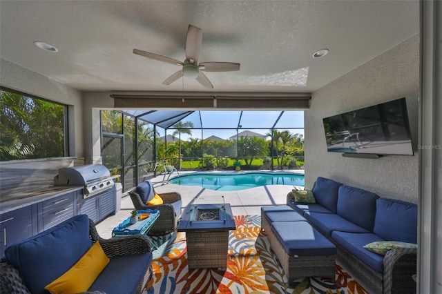 4516 Renwick Dr, Parrish, FL 34219 - swimming pool featuring an outdoor living space with a fire pit, a patio area, a ceiling fan, exterior kitchen, and a lanai