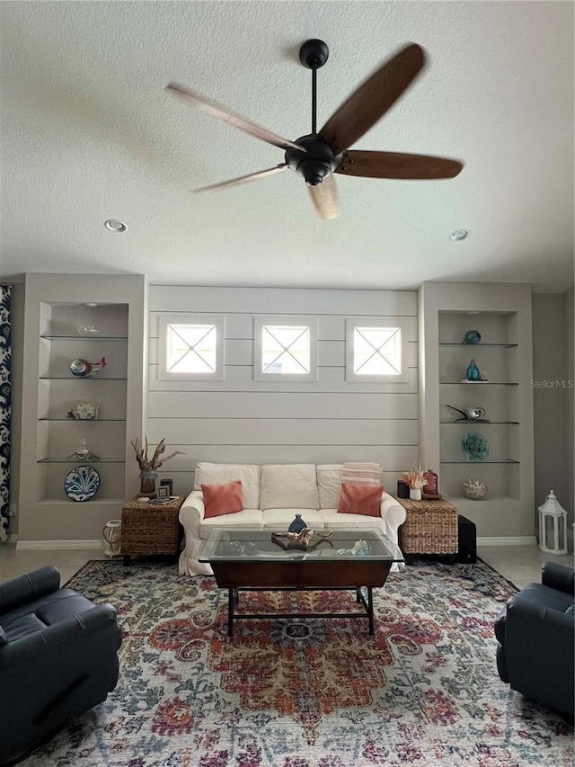 4516 Renwick Dr, Parrish, FL 34219 - carpeted living room featuring a ceiling fan, built in features, a textured ceiling, and healthy amount of natural light