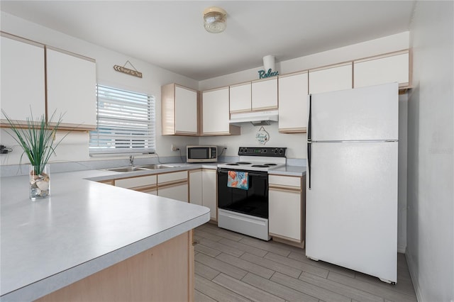 kitchen featuring under cabinet range hood, white appliances, a sink, white cabinets, and light countertops