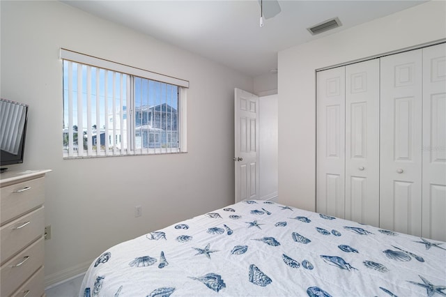 bedroom with a closet, visible vents, and ceiling fan