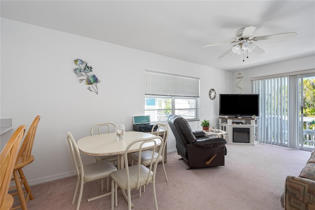 dining room with light carpet, a wealth of natural light, and a ceiling fan