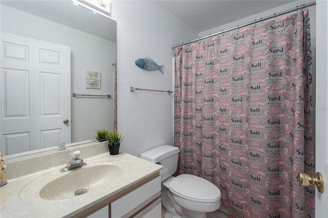 bathroom with curtained shower, vanity, and toilet