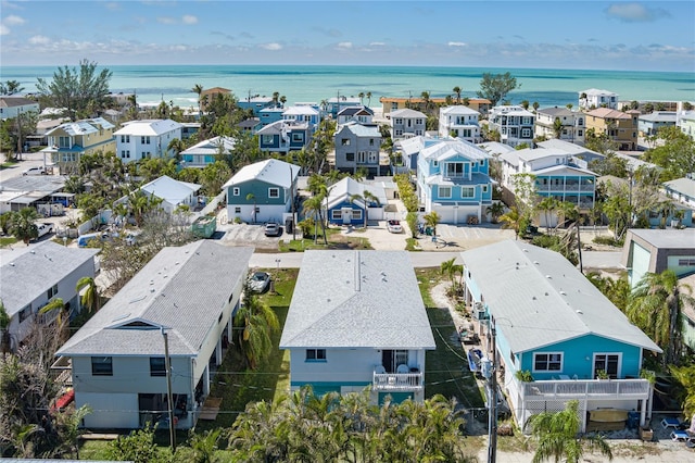 drone / aerial view with a water view and a residential view