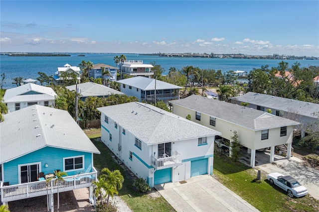 birds eye view of property with a water view and a residential view