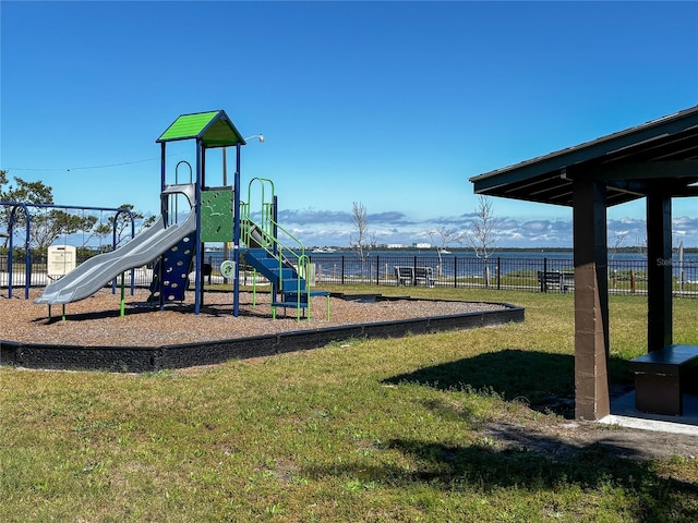 communal playground with fence and a lawn