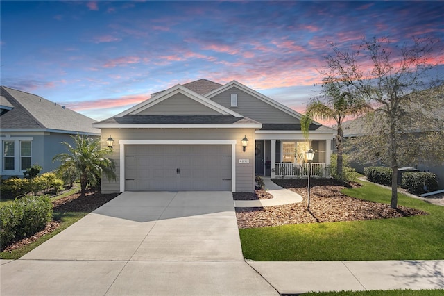 view of front of property with an attached garage, covered porch, and driveway