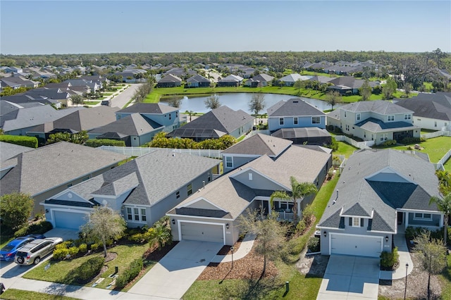 drone / aerial view featuring a residential view and a water view