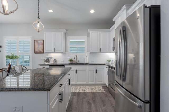 kitchen with white cabinetry, tasteful backsplash, appliances with stainless steel finishes, and a sink