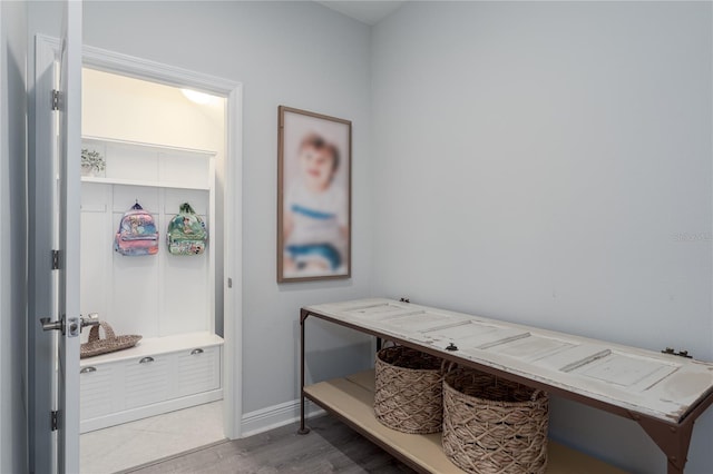 mudroom with baseboards and wood finished floors