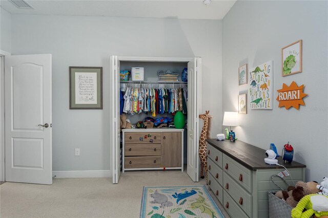 bedroom with baseboards, visible vents, light carpet, and a closet