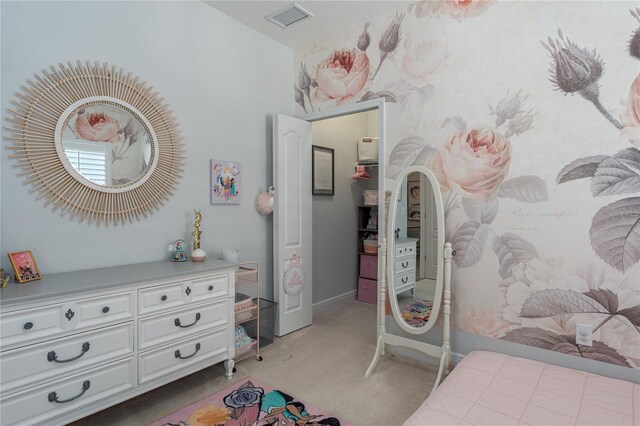 bedroom featuring visible vents, light carpet, and baseboards