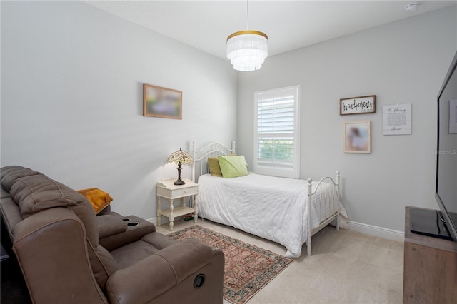 bedroom with baseboards and light carpet