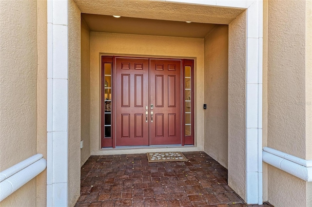 doorway to property with stucco siding