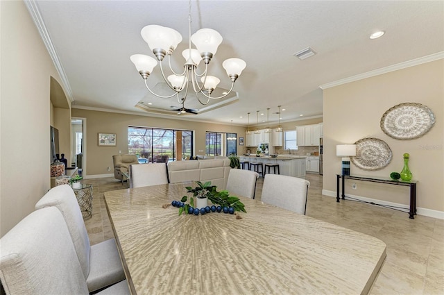 dining space with baseboards, visible vents, crown molding, a chandelier, and recessed lighting