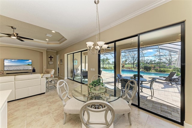 dining room with visible vents, a sunroom, a tray ceiling, crown molding, and ceiling fan with notable chandelier