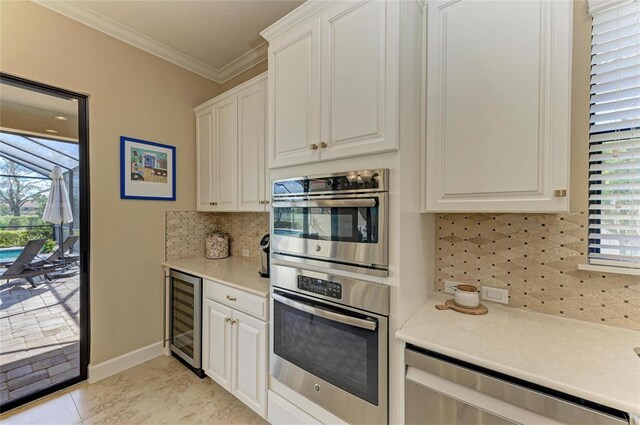 kitchen with beverage cooler, stainless steel appliances, light countertops, and crown molding