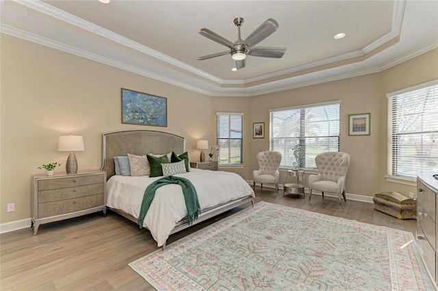 bedroom with baseboards, multiple windows, wood finished floors, and crown molding