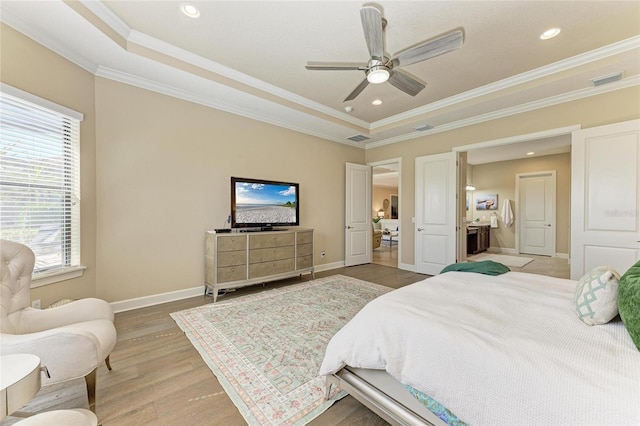 bedroom featuring ornamental molding, light wood-style flooring, and baseboards