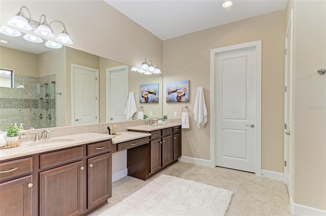 bathroom featuring double vanity, a shower stall, a sink, and tile patterned floors