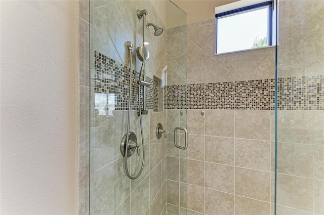 bathroom featuring a stall shower and a textured wall